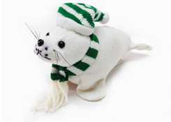 Plush white seal wearing a green and white striped knit hat and scarf